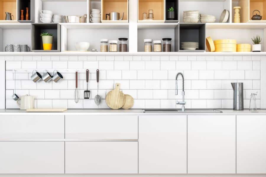 kitchen sink and cabinets with organized stuff 