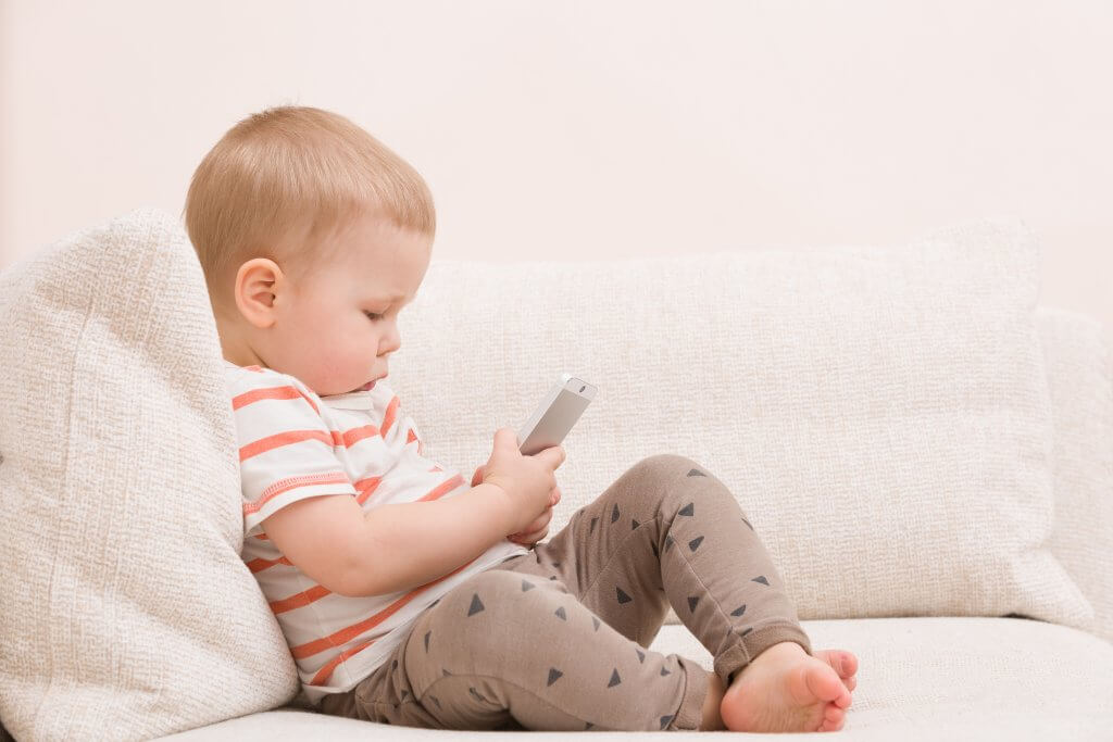 child starting at cell phone