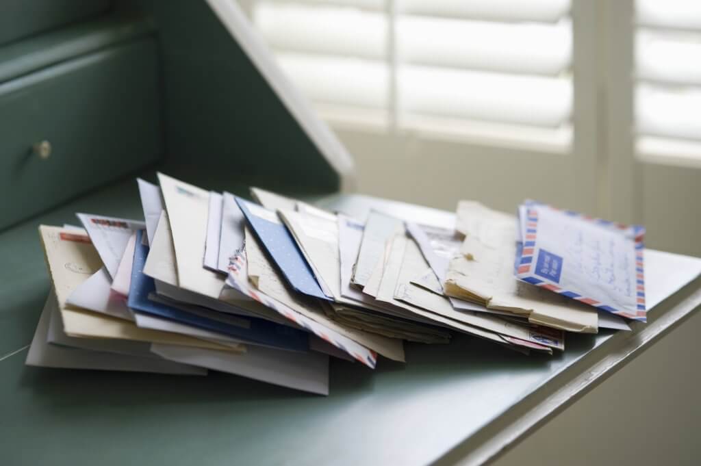 stack of mail on a desk