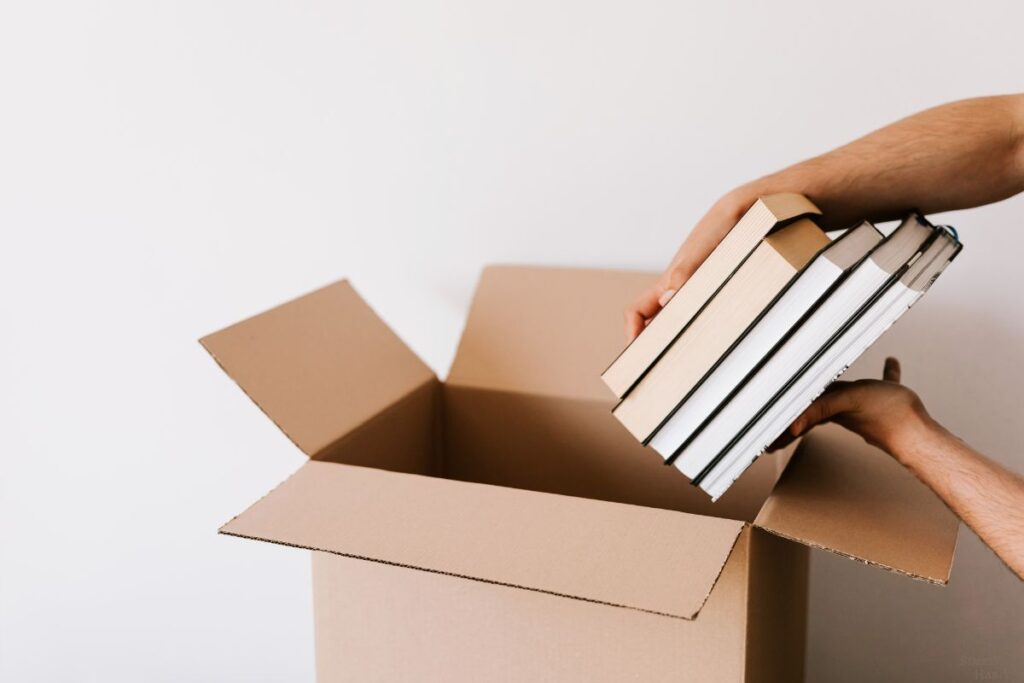 books being placed into a box