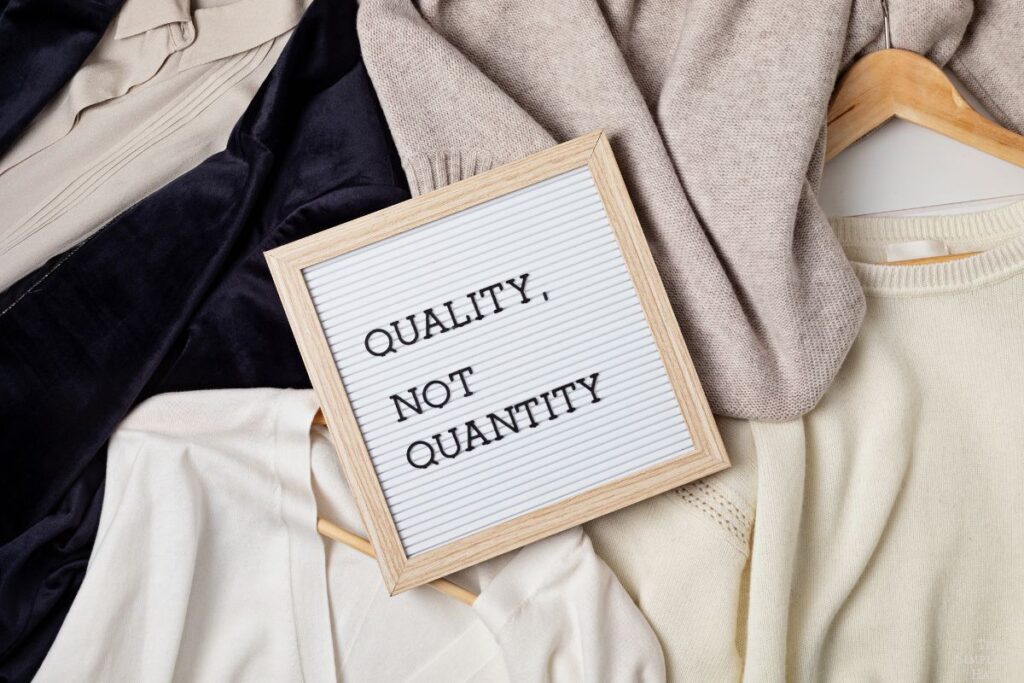 quality over quantity sign on top of clothes