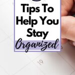 planner open and a person is writing something which is obscured by the words: 5 Tips To Help You Stay Organized