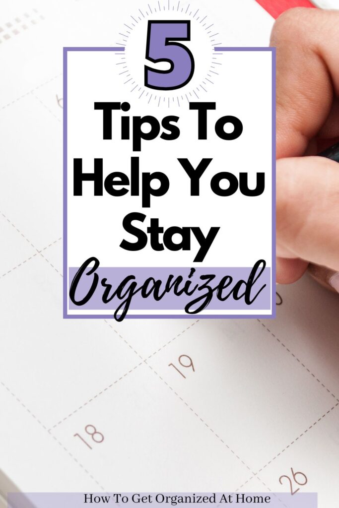 planner open and a person is writing something which is obscured by the words: 5 Tips To Help You Stay Organized