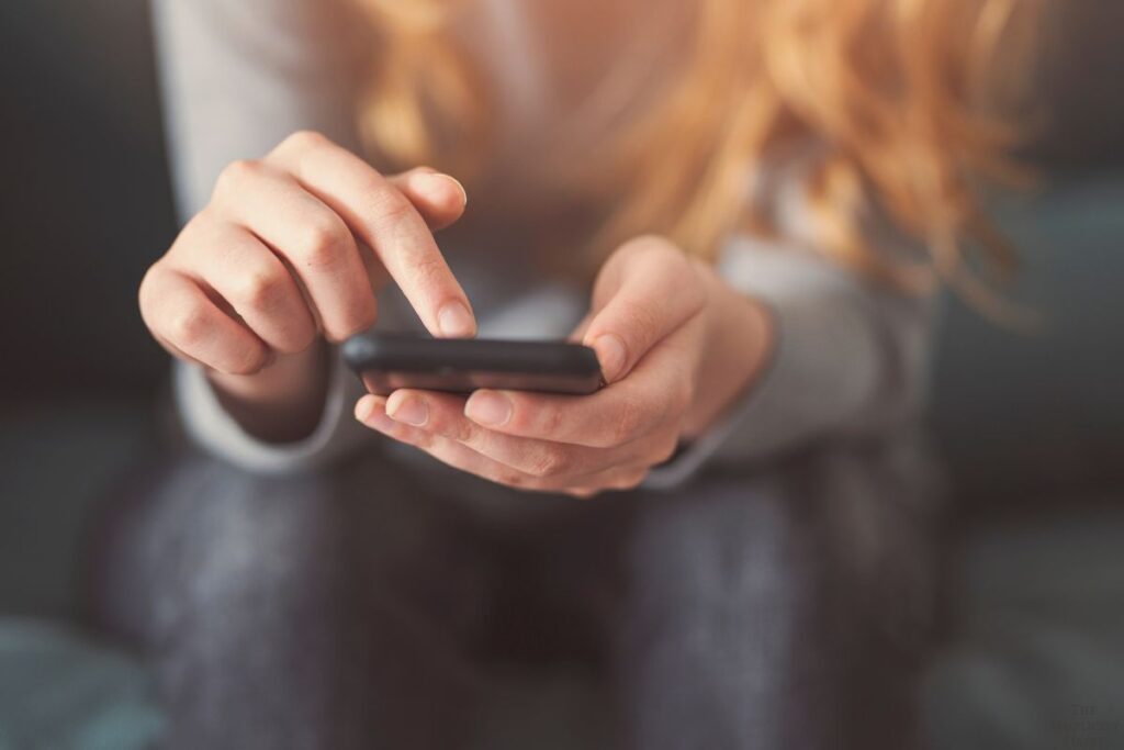 woman typing on her phone