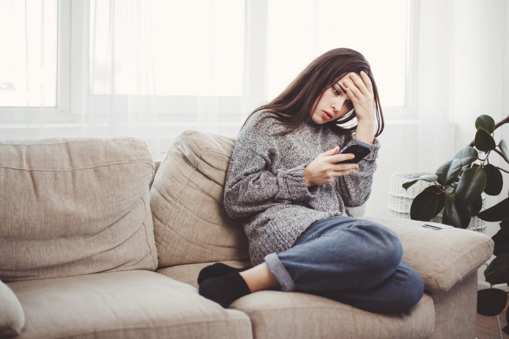 woman looking at cell phone