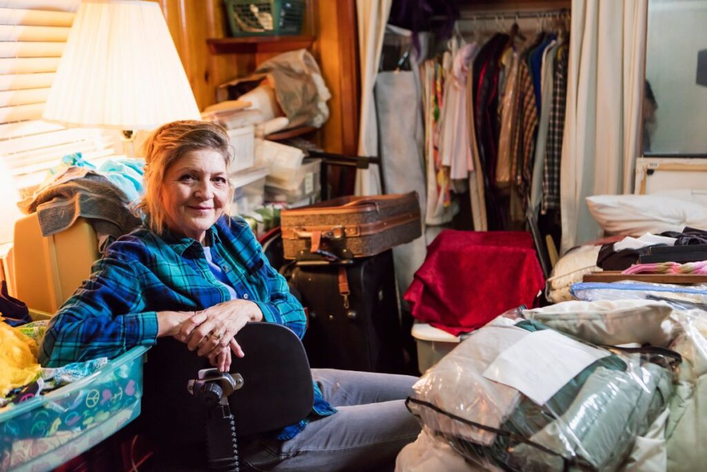 woman surrounded by a lot of stuff in her home