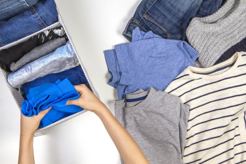 image of a woman folding clothing
