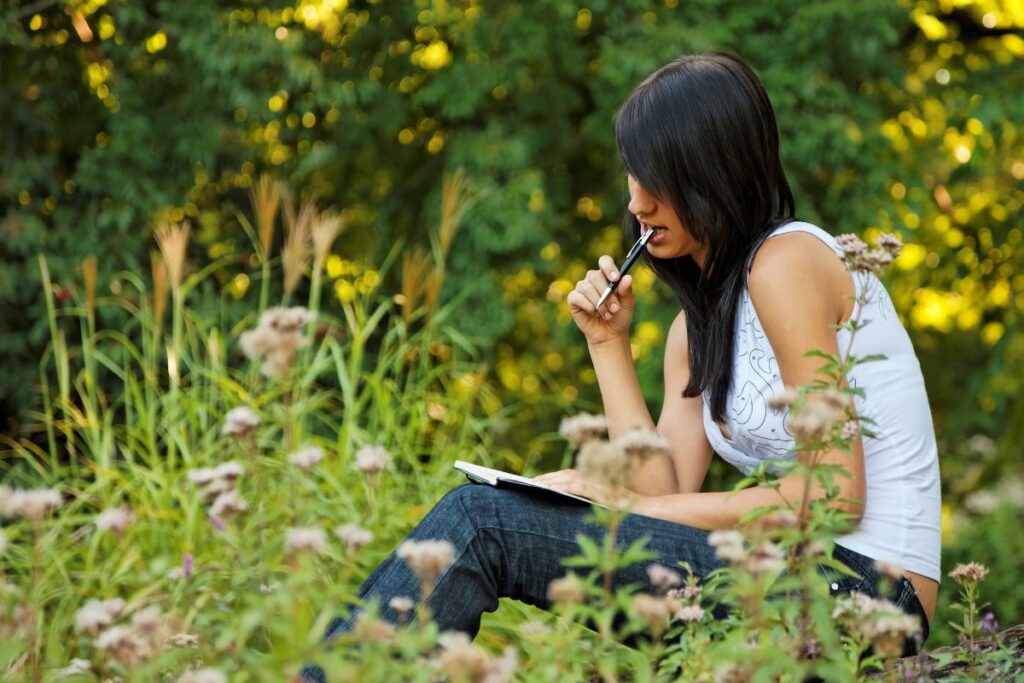 woman journaling outside