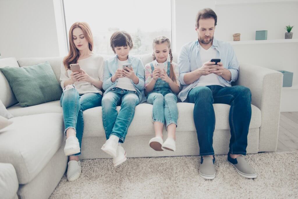 family staring at phone screens