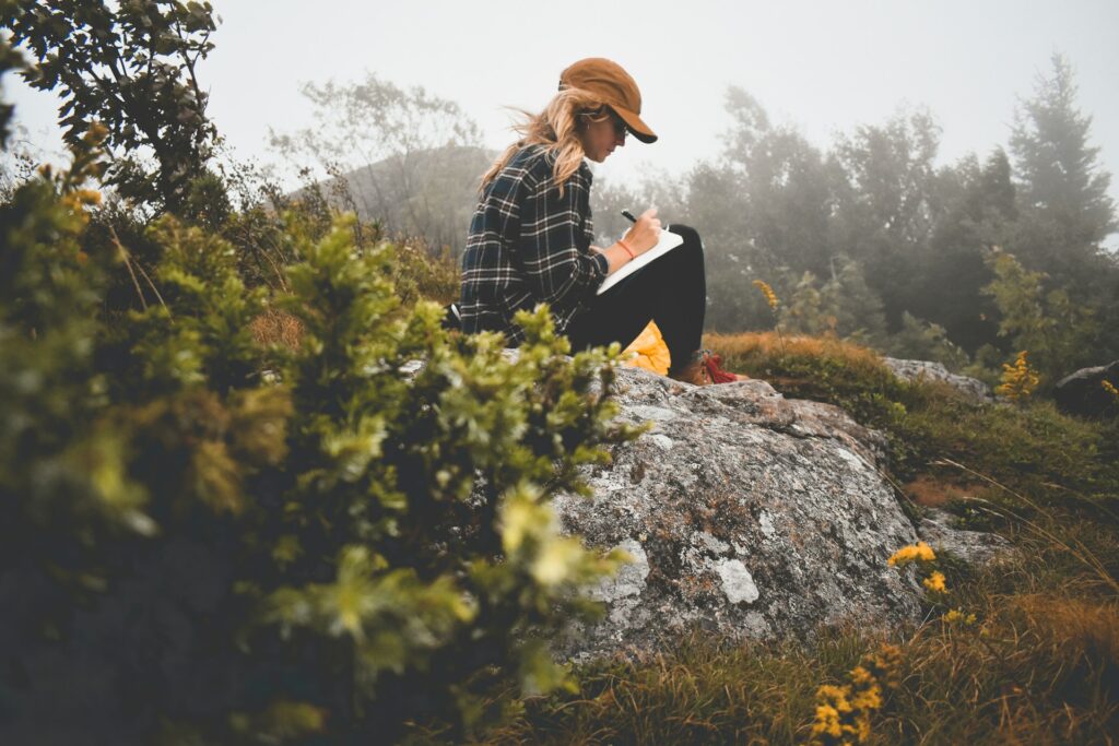 woman journaling outdoors