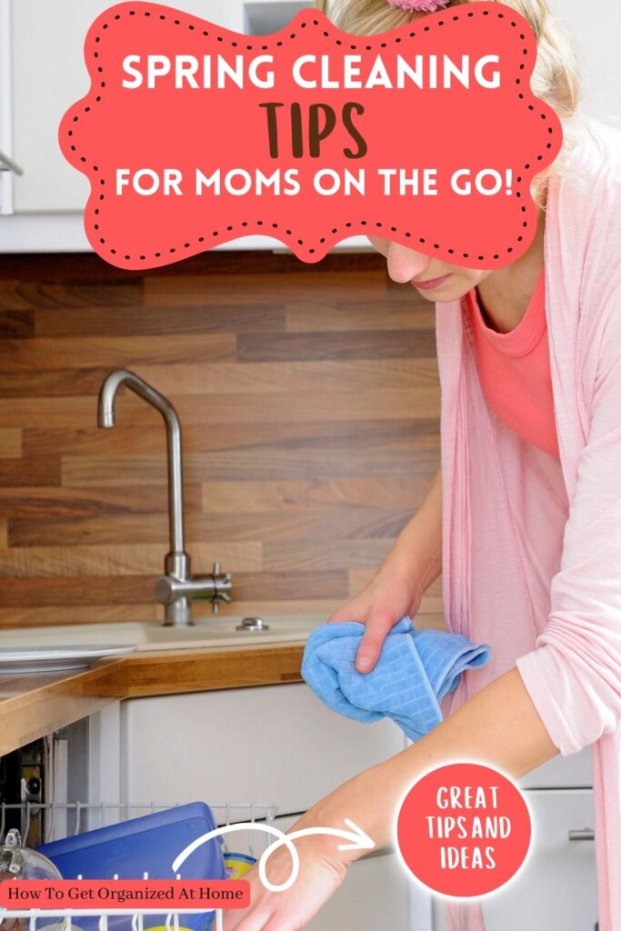 the words 'spring cleaning tips for moms on the go' appear in a butterfly shape in coral above an image of a mom cleaning the dishes.