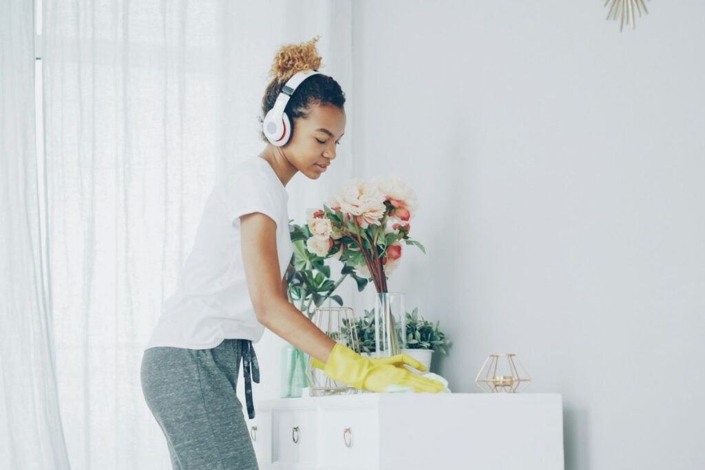 girl cleaning with headphones on